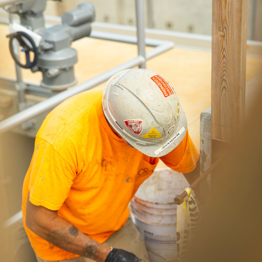 BH Craig crew member in hardhat working on concrete at atreatment plant